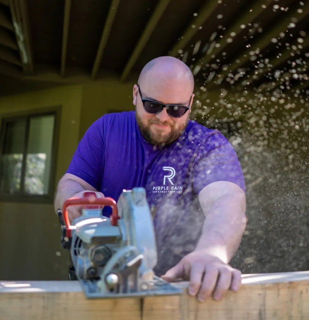 Purple Rain crew member cutting decking on a Central Oregon build