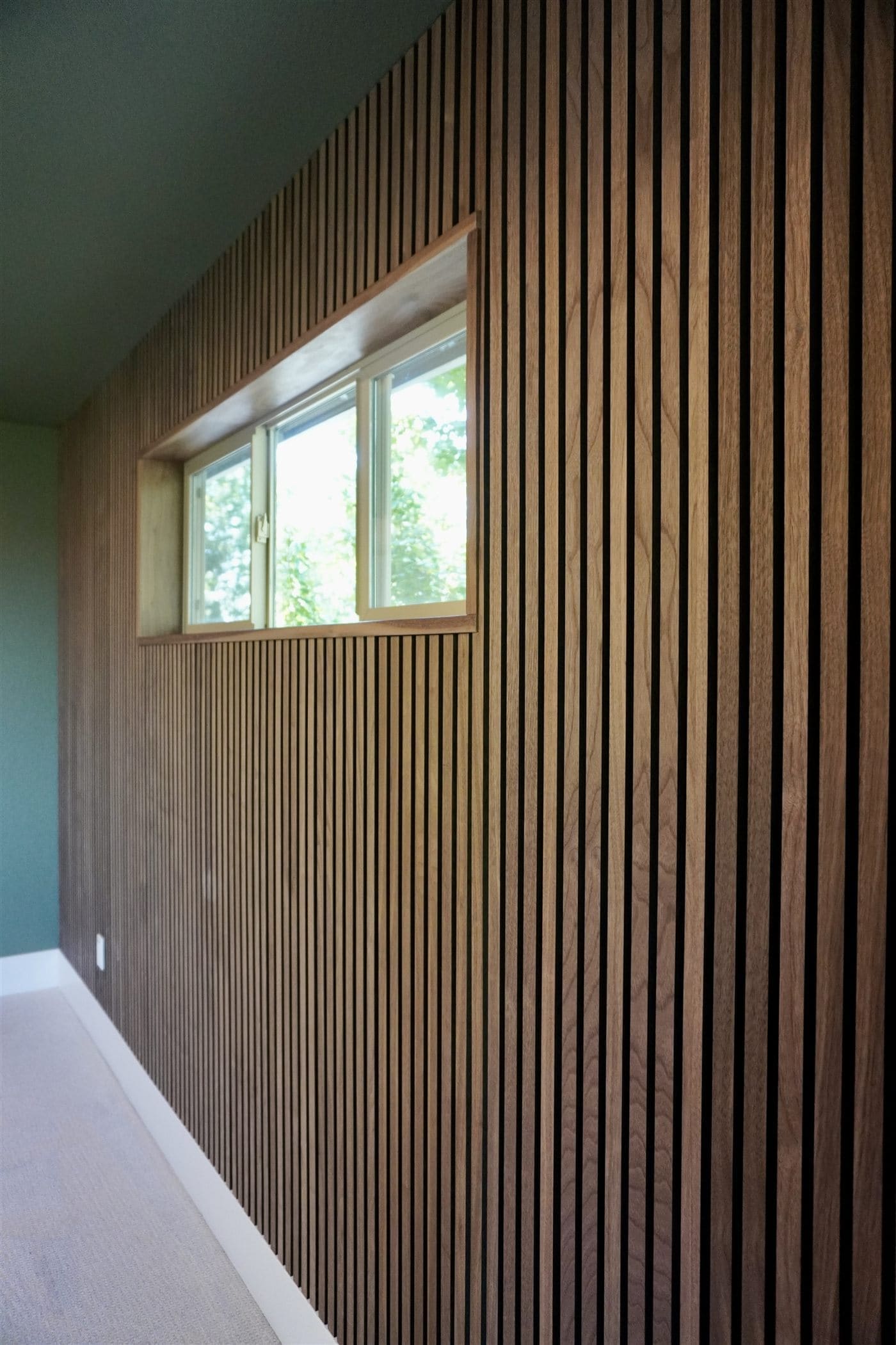 Custom wood slat accent wall built by Purple Rain Construction